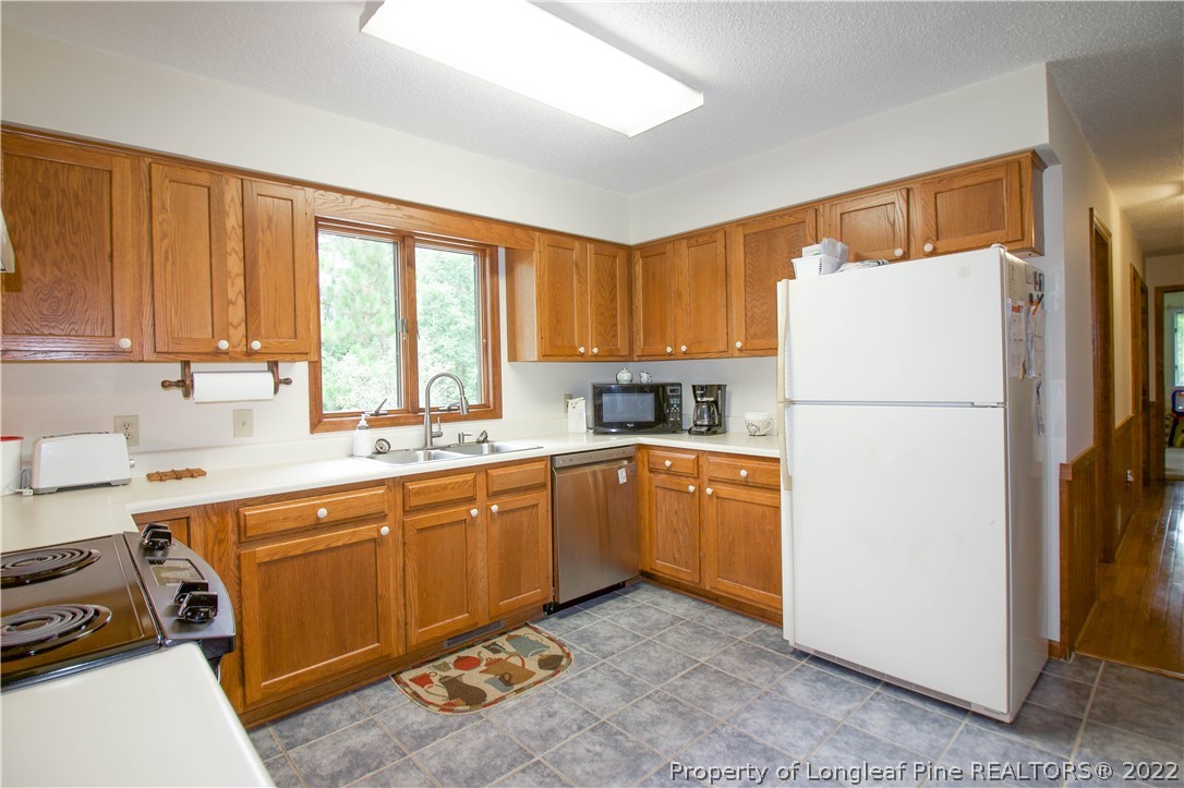 144 Manor Road Carthage, NC 28327 - Photo 47 of 47 a kitchen with a refrigerator and a sink