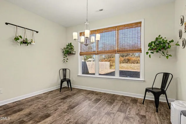 a view of a livingroom with furniture and a window