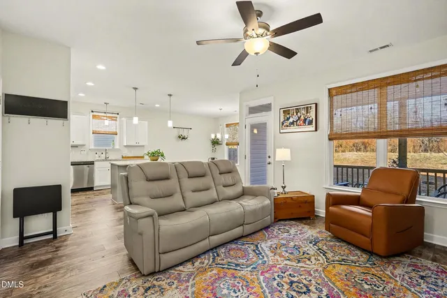 a living room with furniture wooden floor and a window