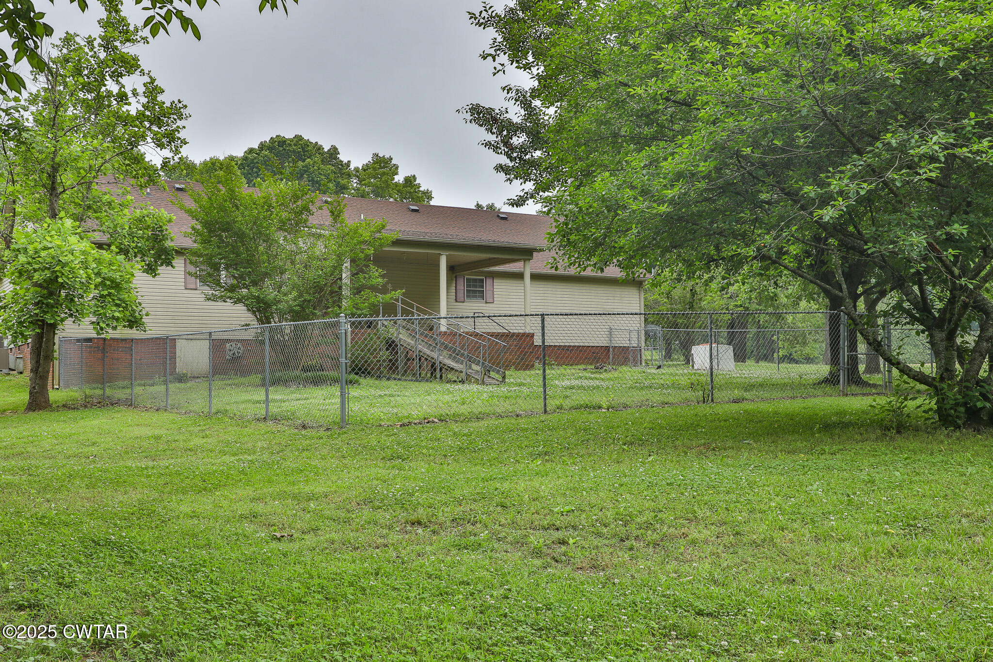 18 Tollie Markham Road Dyer, TN 38330 - Photo 19 of 27 a backyard of a house with plants and large tree