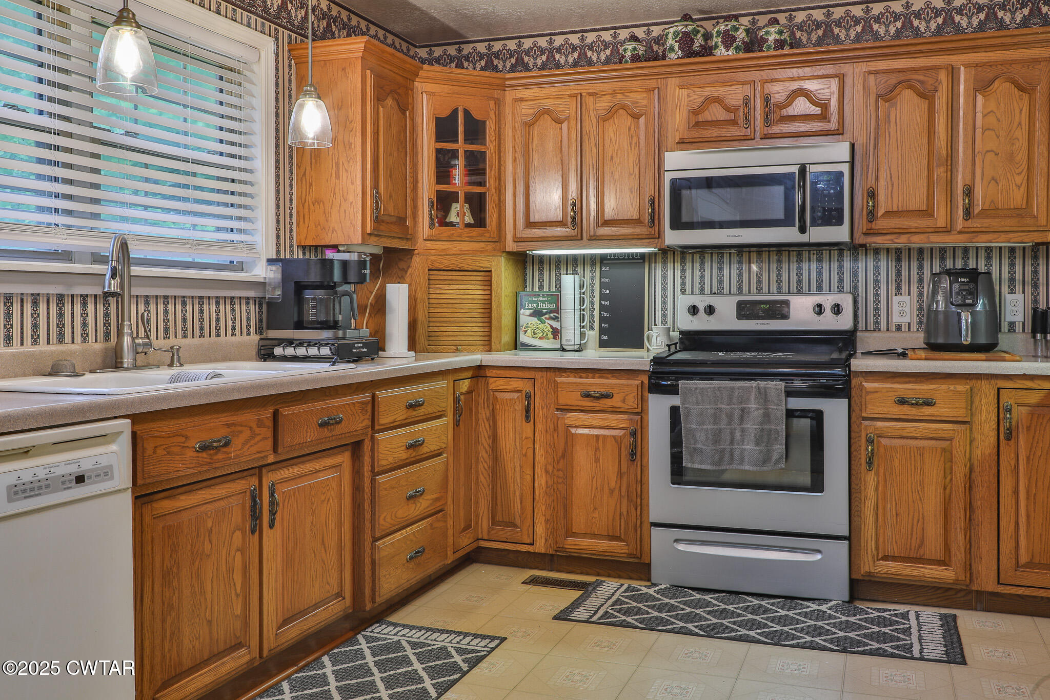 18 Tollie Markham Road Dyer, TN 38330 - Photo 4 of 27 a kitchen with stainless steel appliances granite countertop a stove a sink and a microwave