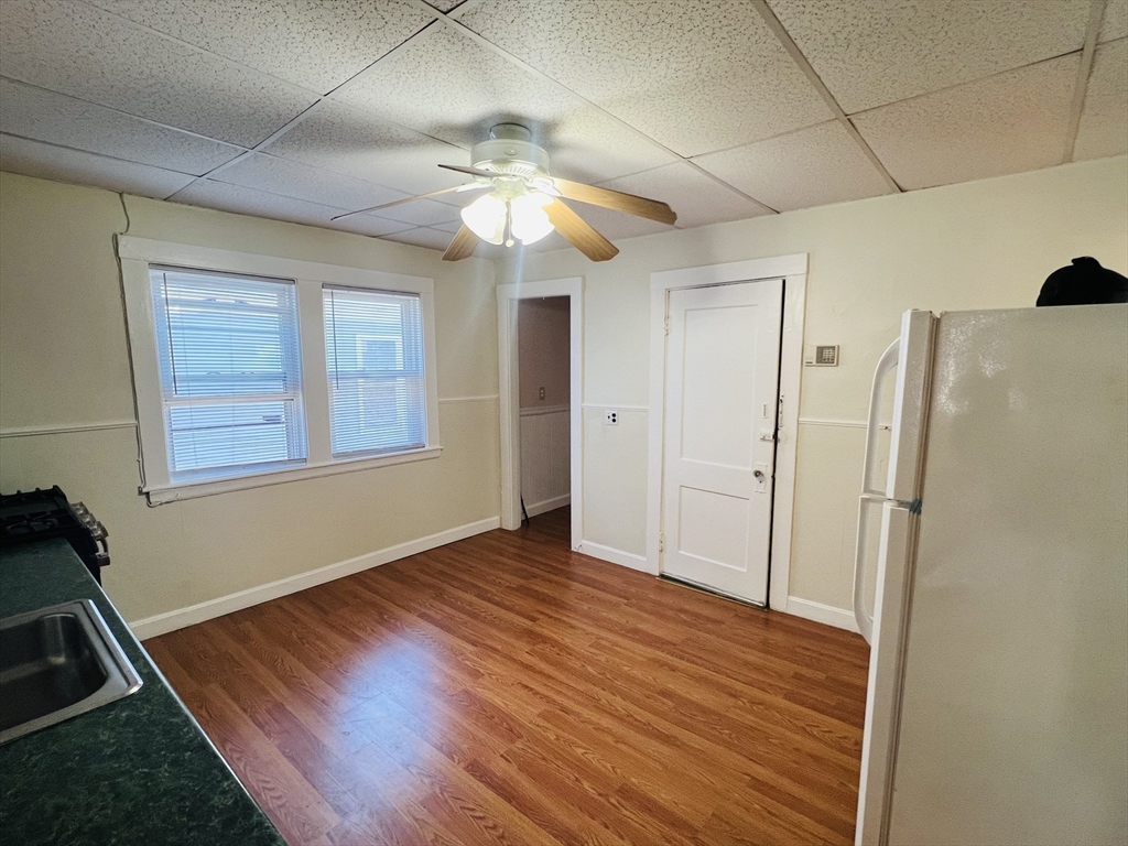 62 Westmore Road, Unit 2 Boston, MA 02126 - Photo 4 of 13 a view of an empty room with wooden floor and a window