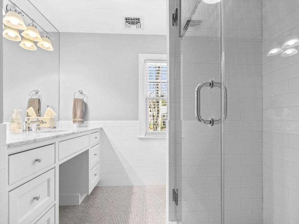 35 Lehigh Road Wellesley, MA 02482 - Photo 20 of 23 a bathroom with a shower sink and mirror