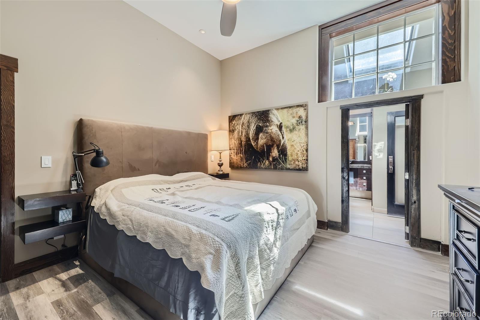 2971 Fall River Road Idaho Springs, CO 80452 - Photo 16 of 42 a bedroom with a large bed and a large mirror