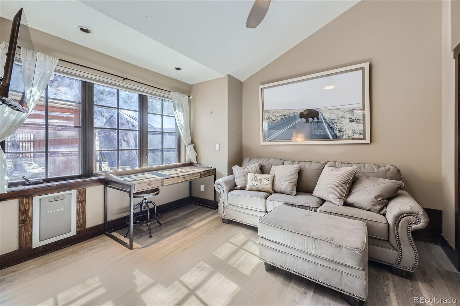 2971 Fall River Road Idaho Springs, CO 80452 - Photo 22 of 42 a living room with furniture and a large window
