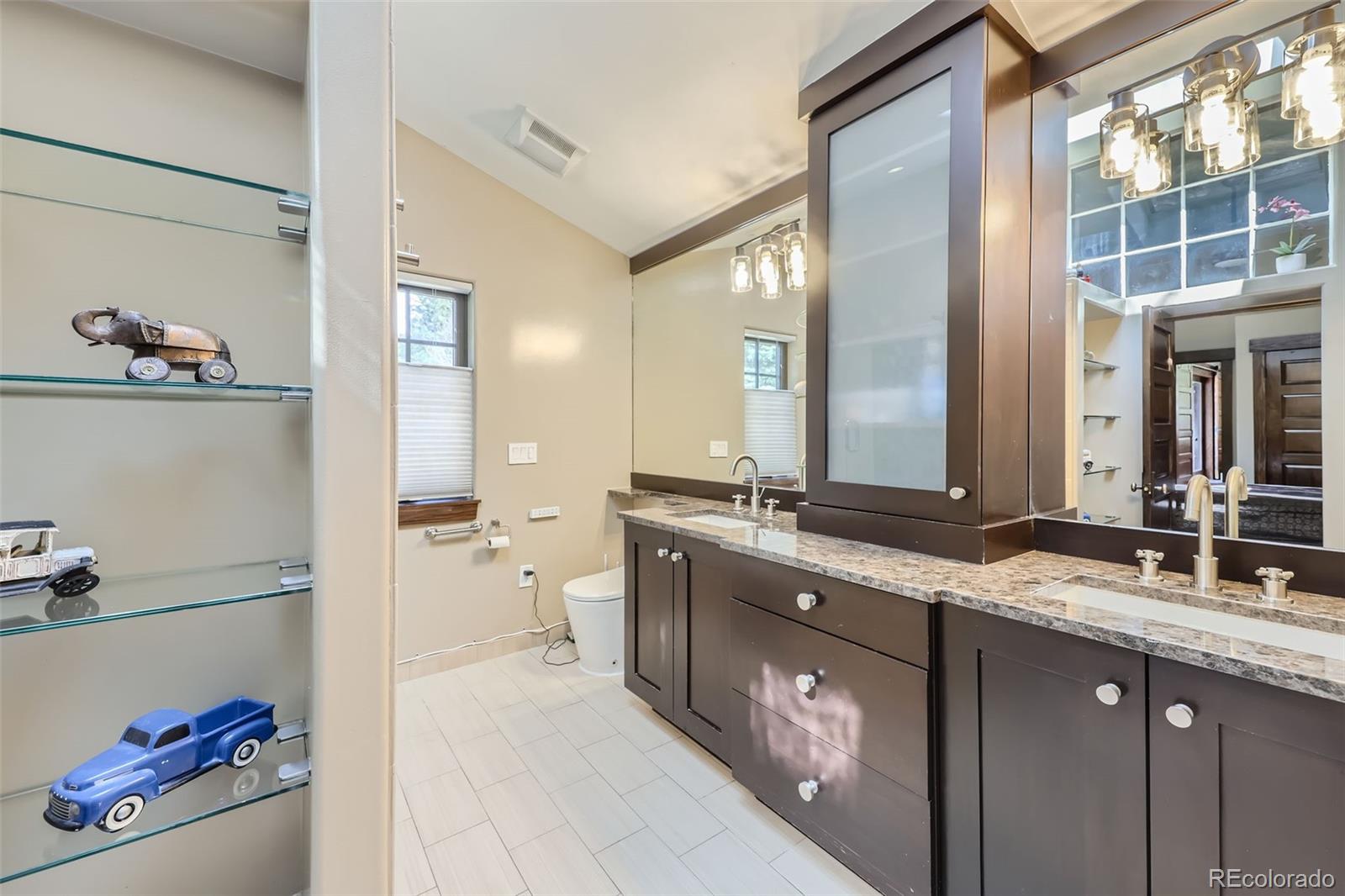 2971 Fall River Road Idaho Springs, CO 80452 - Photo 23 of 42 a spacious bathroom with a granite countertop sink a mirror and a bathtub