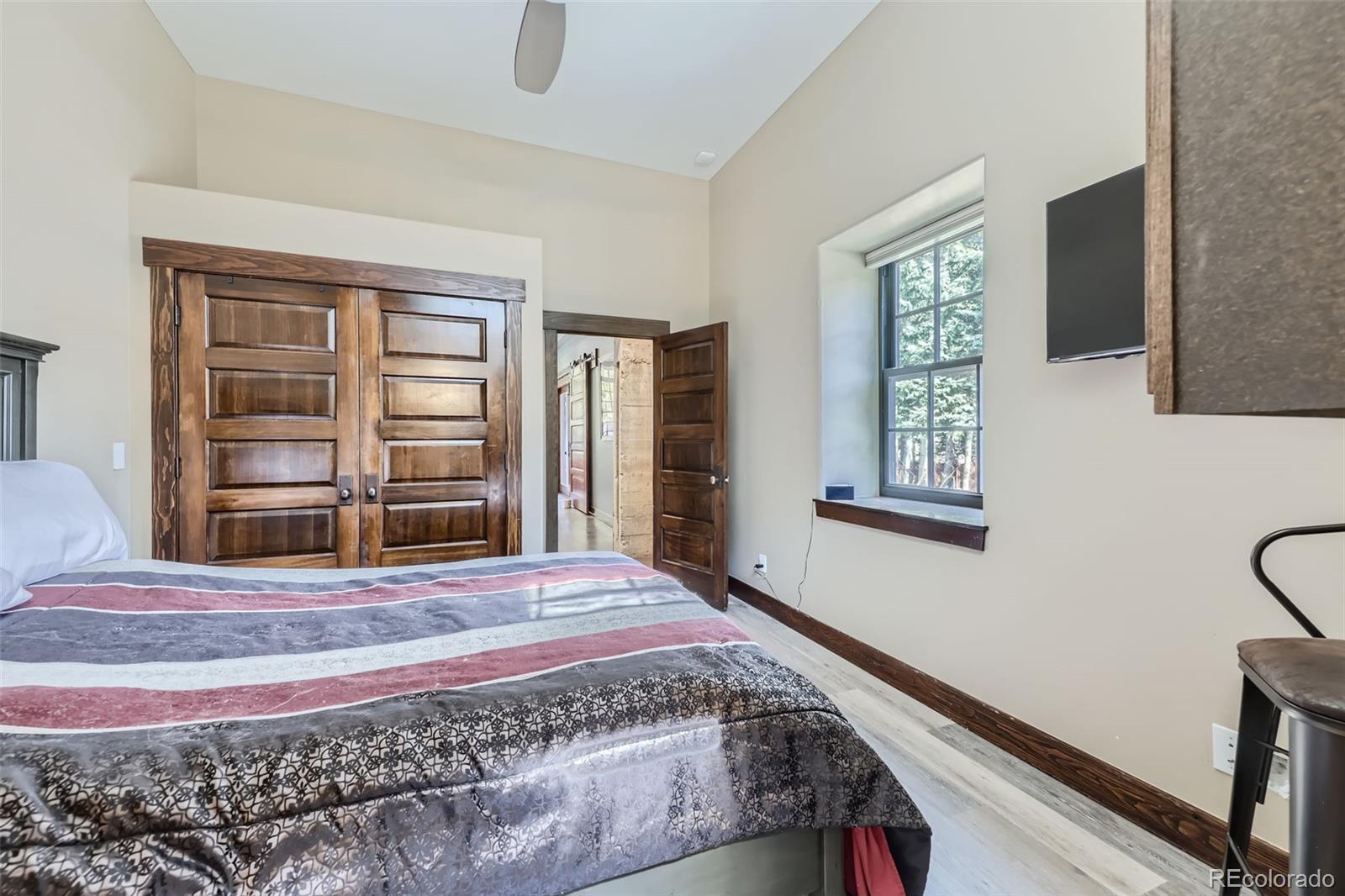 2971 Fall River Road Idaho Springs, CO 80452 - Photo 24 of 42 a bedroom with a bed and a window
