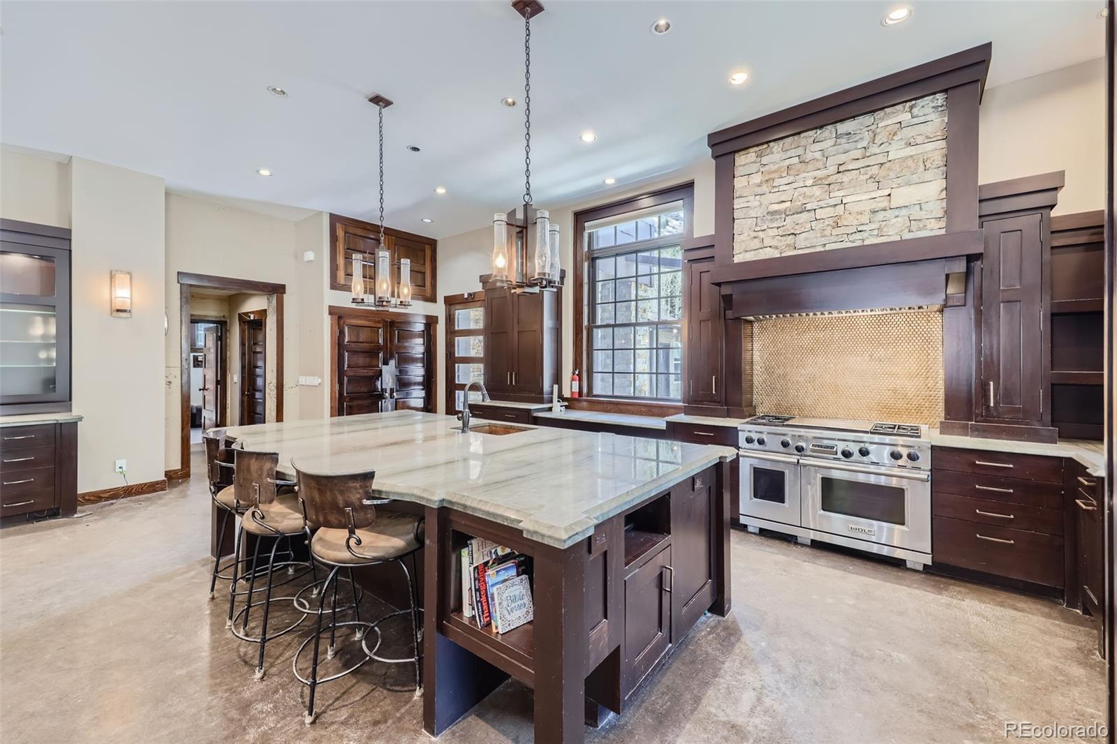 2971 Fall River Road Idaho Springs, CO 80452 - Photo 8 of 42 a kitchen with stainless steel appliances granite countertop a stove top oven a refrigerator a sink and a stove