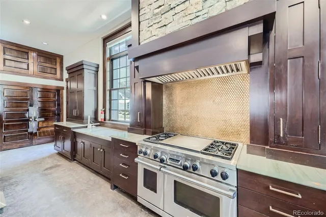 a open kitchen with stainless steel appliances granite countertop a stove refrigerator and cabinets