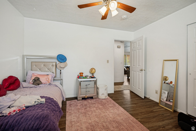 6709 Acoma Road, Unit 239 Midvale, UT 84047 - Photo 12 of 38 6711 - Main level bedroom 2. Wood-finish flooring, white walls, and a ceiling fan with integrated lighting