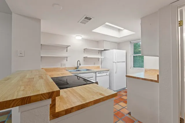 a kitchen that has a sink and a stove in it