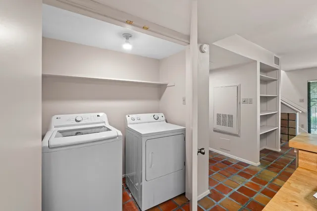 a view of a pathway of a house with large trees