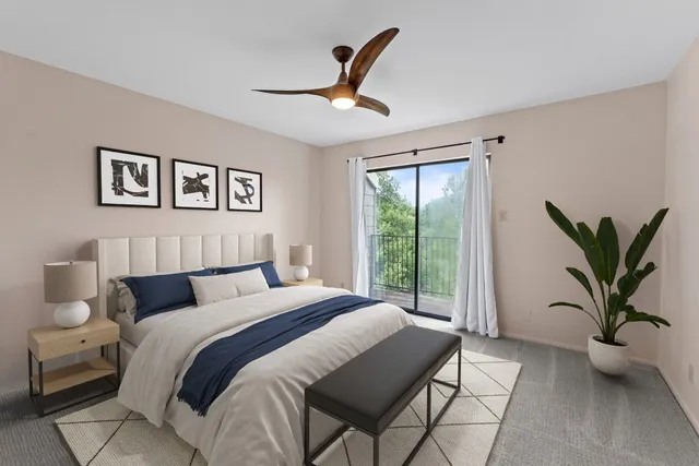 a bedroom with a large bed and a window