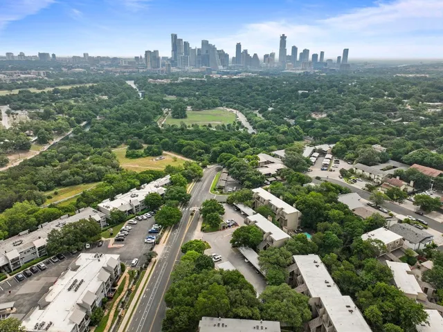 an aerial view of residential houses with city view