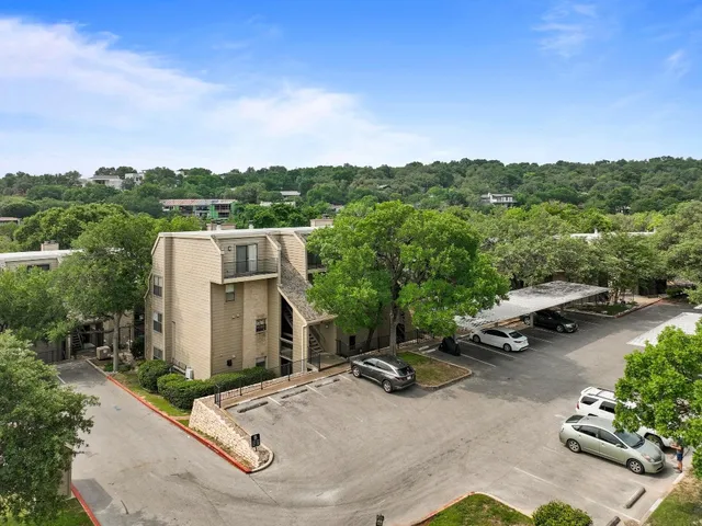 an aerial view of residential houses with city view