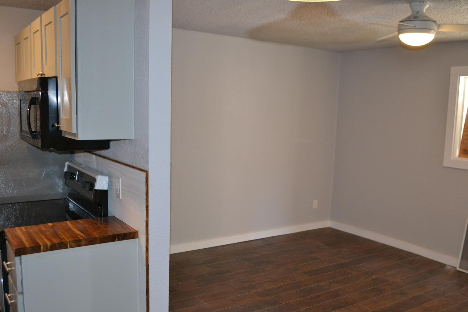 1812 14th Street, Unit 5 Lubbock, TX 79401 - Photo 5 of 10 a bedroom with a bed and a mirror