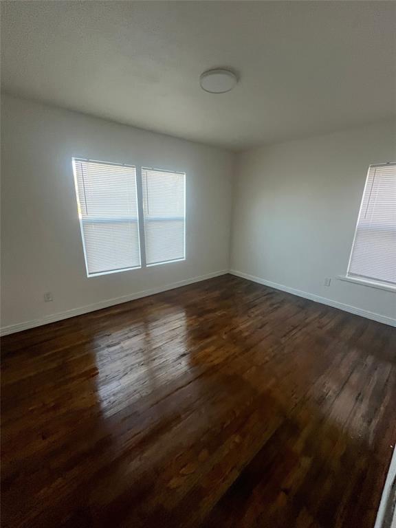 210 Clyde Street Abilene, TX 79605 - Photo 13 of 15 an empty room with wooden floor and windows