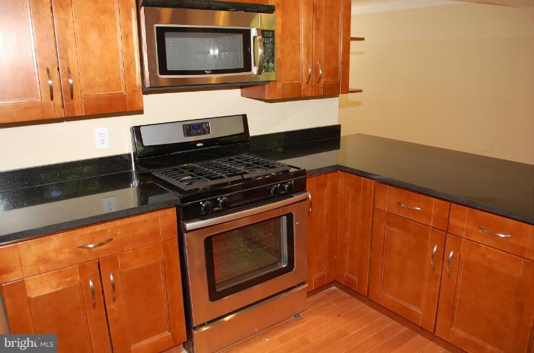 6216 Stevens Forest Road Columbia, MD 21045 - Photo 4 of 30 a stove top oven sitting inside of a kitchen