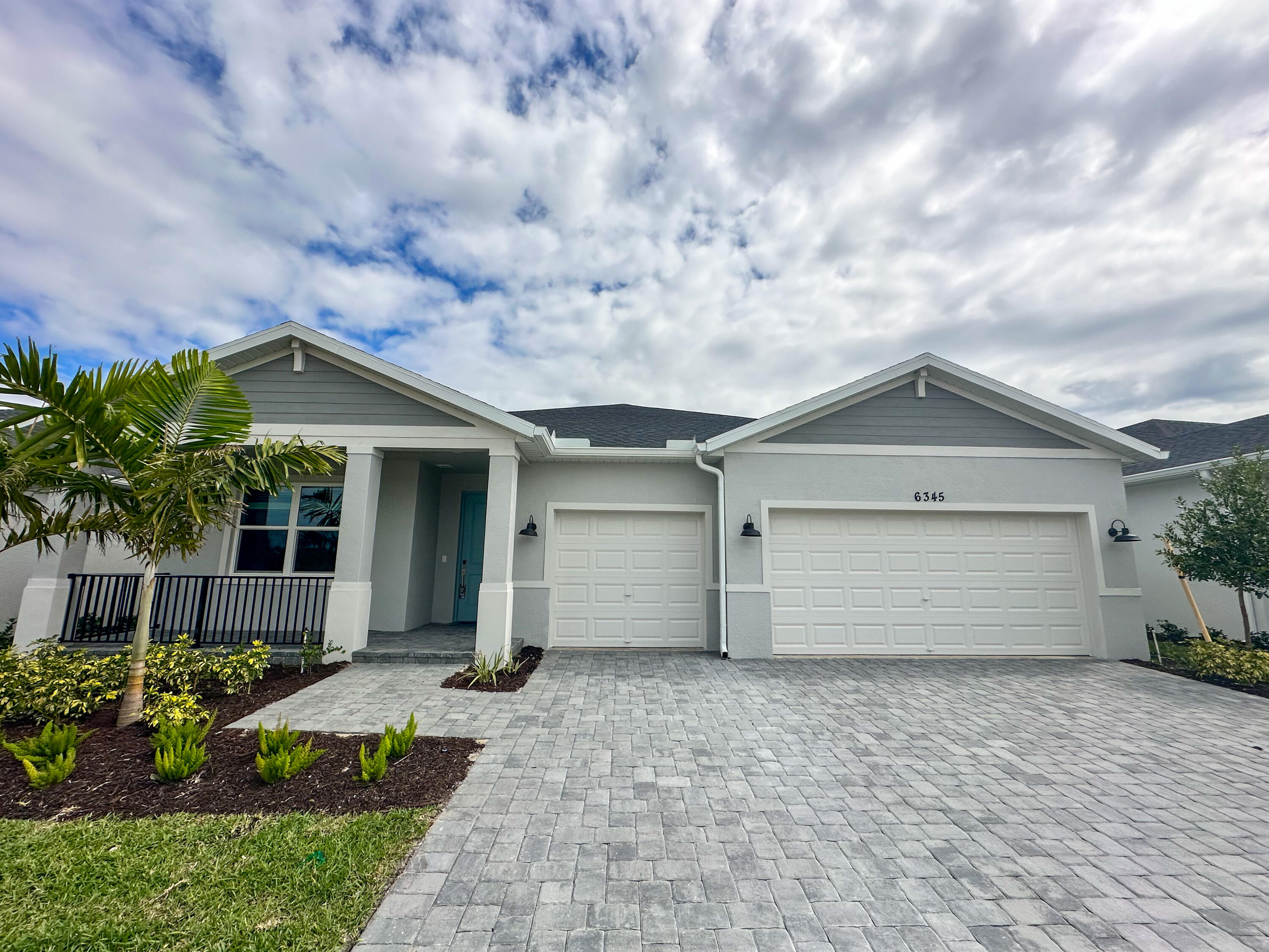 6345 Cloverdale Avenue Port St. Lucie, FL 34987 - Photo 1 of 37 a front view of house with a garden