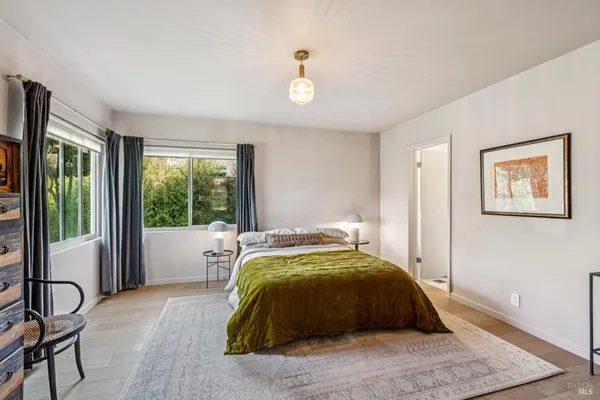 a bed sitting in a bedroom next to a window