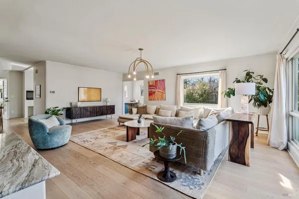 a living room with fireplace furniture and a window