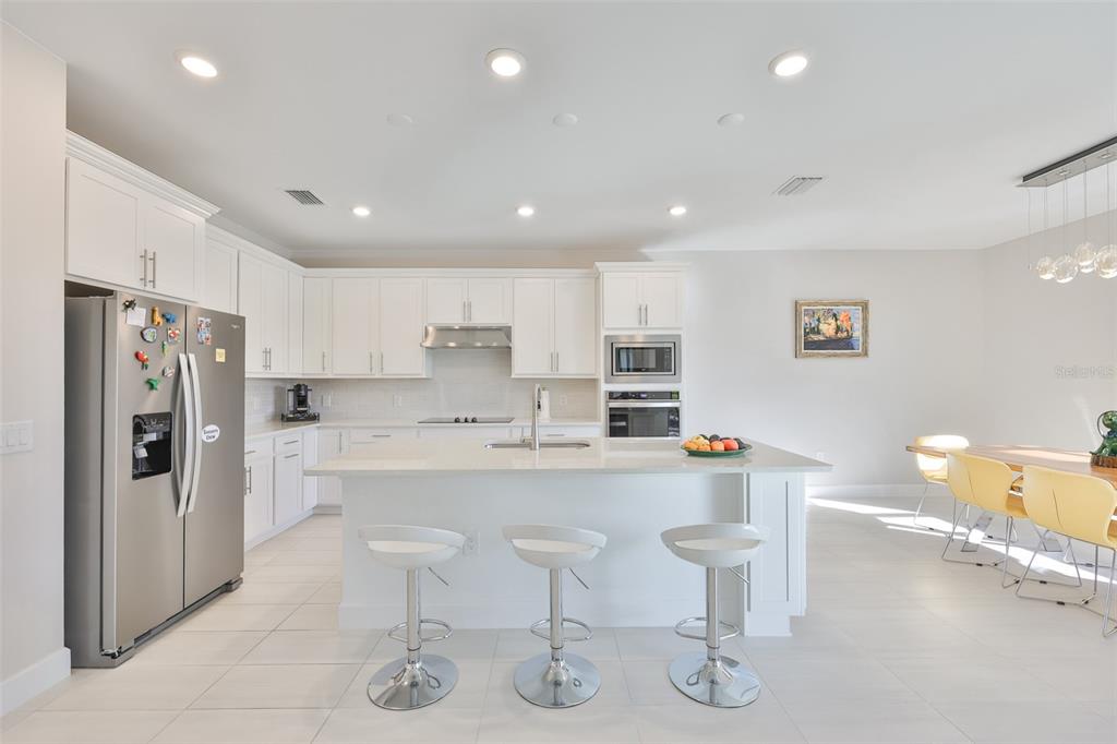 16320 Hidden Oak Loop Bradenton, FL 34211 - Photo 13 of 56 a kitchen with stainless steel appliances granite countertop a refrigerator and a stove top oven