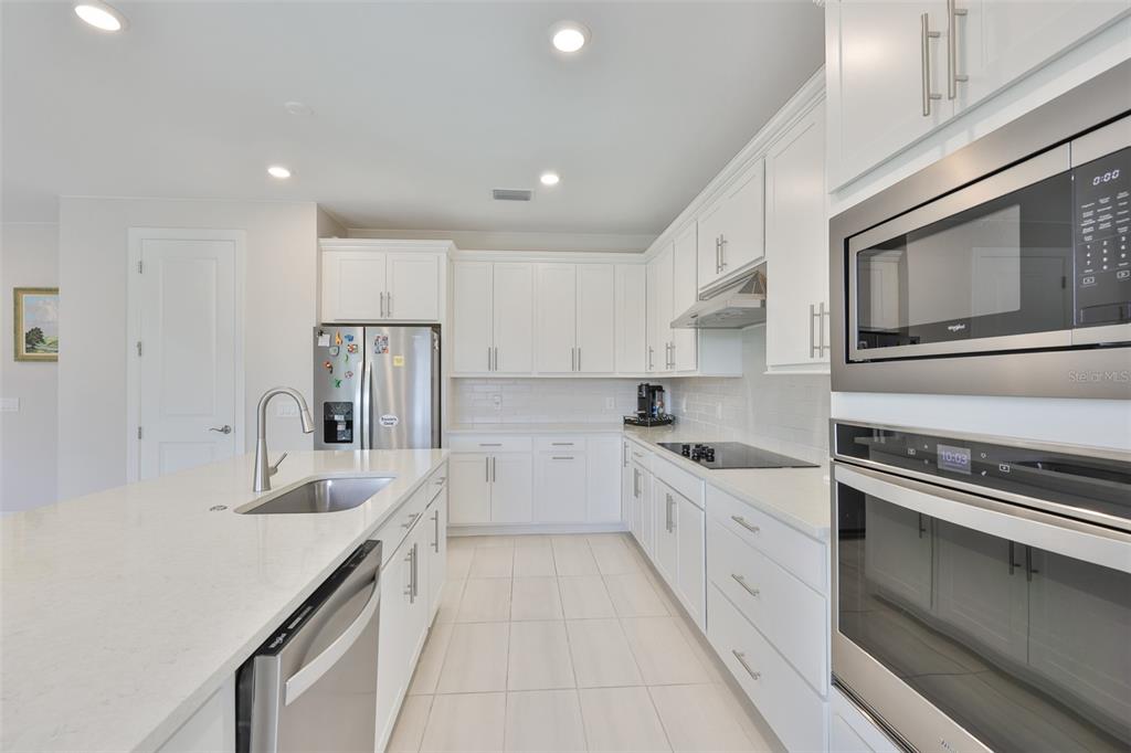 16320 Hidden Oak Loop Bradenton, FL 34211 - Photo 16 of 56 a kitchen with stainless steel appliances granite countertop a sink and cabinets