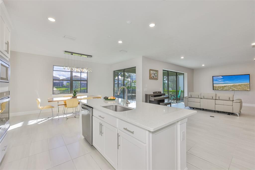 16320 Hidden Oak Loop Bradenton, FL 34211 - Photo 17 of 56 a large white kitchen with a large window