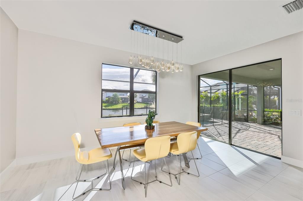 16320 Hidden Oak Loop Bradenton, FL 34211 - Photo 20 of 56 a dining room with furniture and large windows