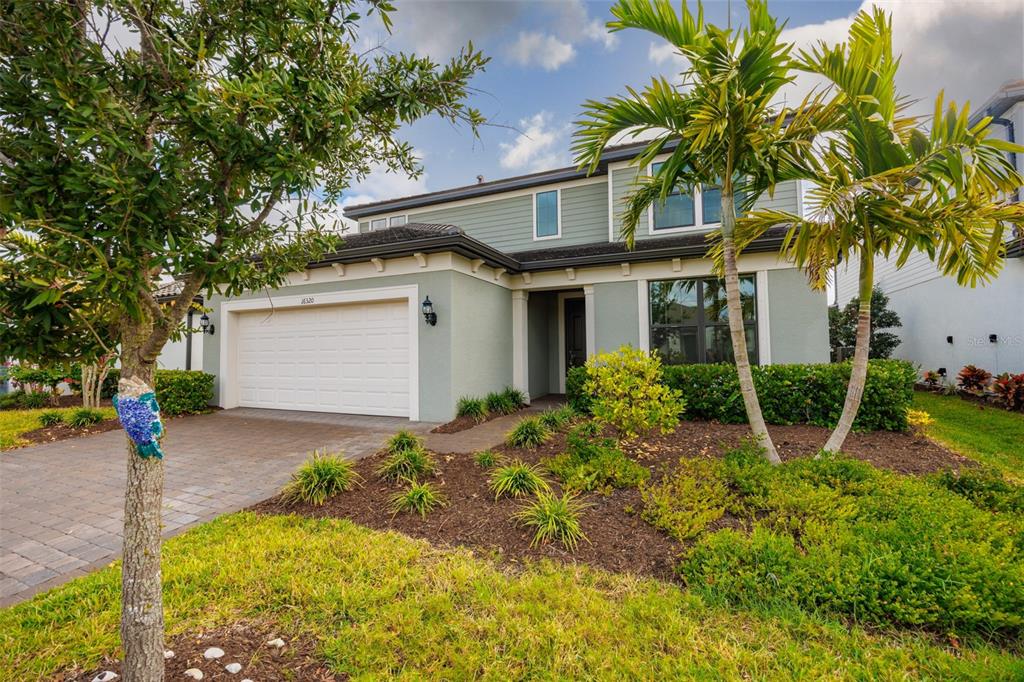 16320 Hidden Oak Loop Bradenton, FL 34211 - Photo 2 of 56 a front view of a house with garden