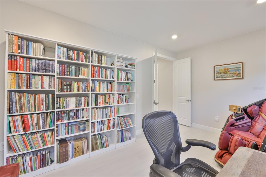 16320 Hidden Oak Loop Bradenton, FL 34211 - Photo 23 of 56 a workspace with a bookshelf and a bookshelf