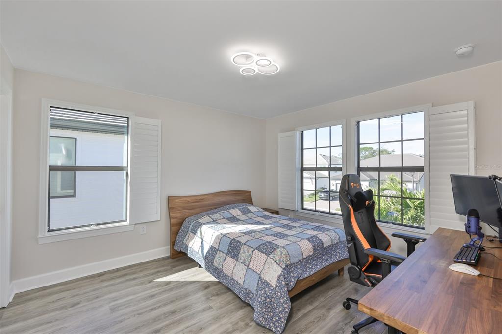 16320 Hidden Oak Loop Bradenton, FL 34211 - Photo 28 of 56 a bedroom with a bed a desk and chair