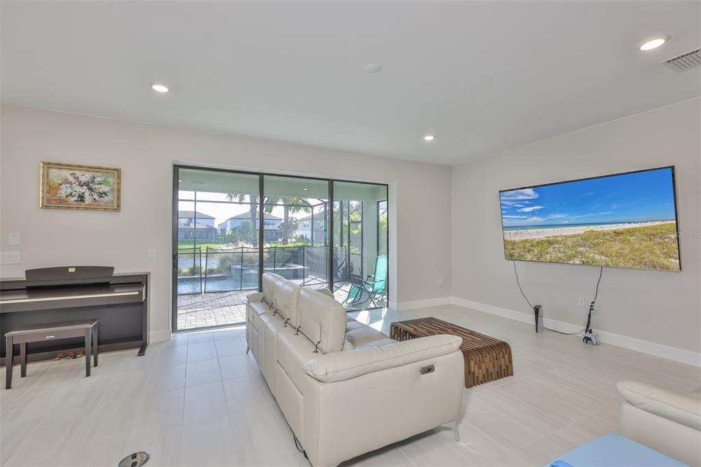 16320 Hidden Oak Loop Bradenton, FL 34211 - Photo 6 of 56 a living room with furniture and a flat screen tv