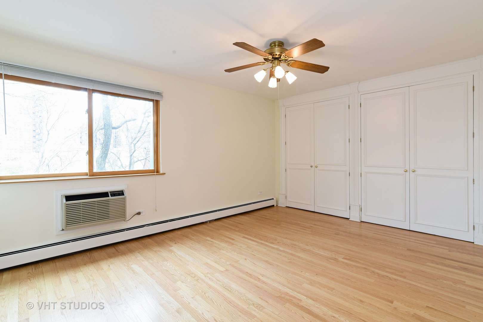 401 West Webster Avenue, Unit 502 Chicago, IL 60614 - Photo 6 of 12 wooden floor in an empty room with a window
