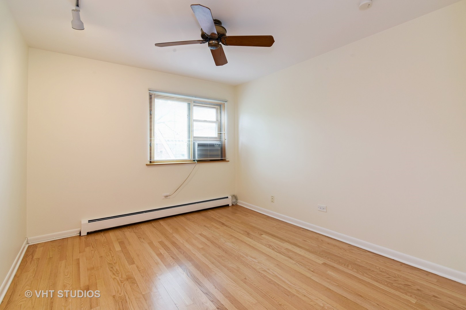 401 West Webster Avenue, Unit 502 Chicago, IL 60614 - Photo 7 of 12 an empty room with a window and a ceiling fan