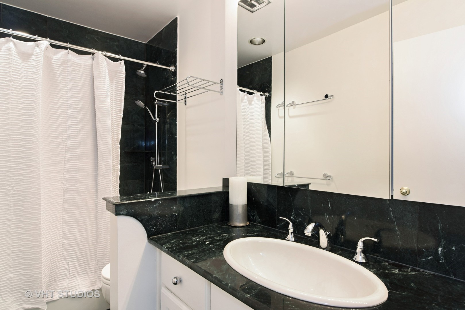 401 West Webster Avenue, Unit 502 Chicago, IL 60614 - Photo 8 of 12 a bathroom with a sink and a mirror