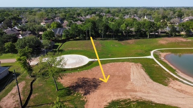 33201 Worthing Lane Fulshear, TX 77441 - Photo 3 of 8 a view of a swimming pool with a garden