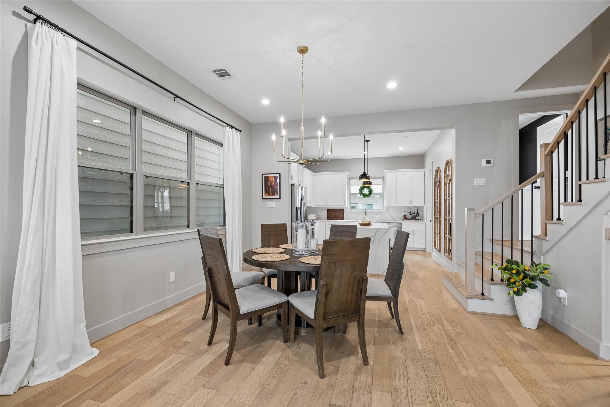 2407 Bevis Street Houston, TX 77008 - Photo 11 of 34 a view of a dining room with furniture window and wooden floor
