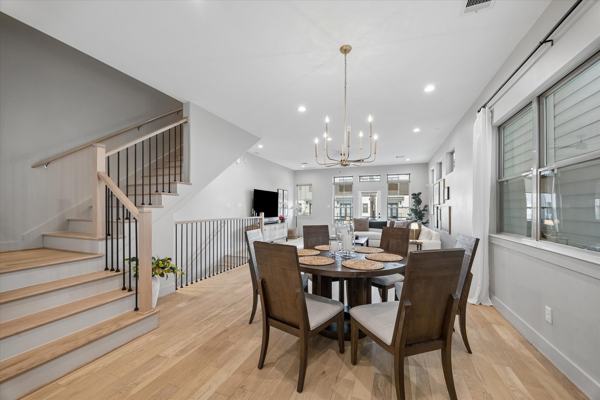 2407 Bevis Street Houston, TX 77008 - Photo 13 of 34 a view of a dining room and livingroom with furniture wooden floor a chandelier