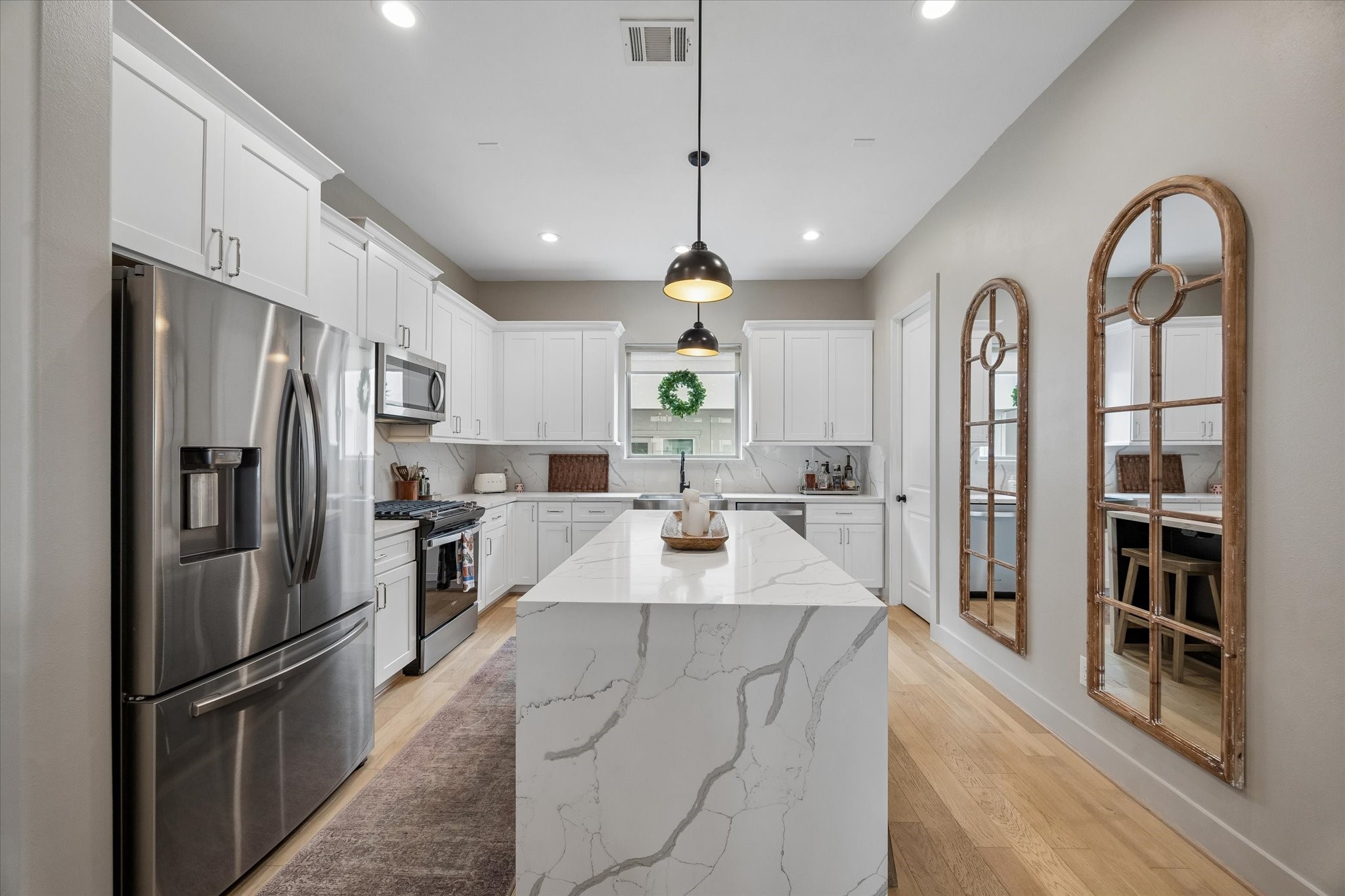 2407 Bevis Street Houston, TX 77008 - Photo 17 of 34 a large kitchen with stainless steel appliances kitchen island granite countertop a refrigerator a stove a sink dishwasher a oven with a dining table and chairs