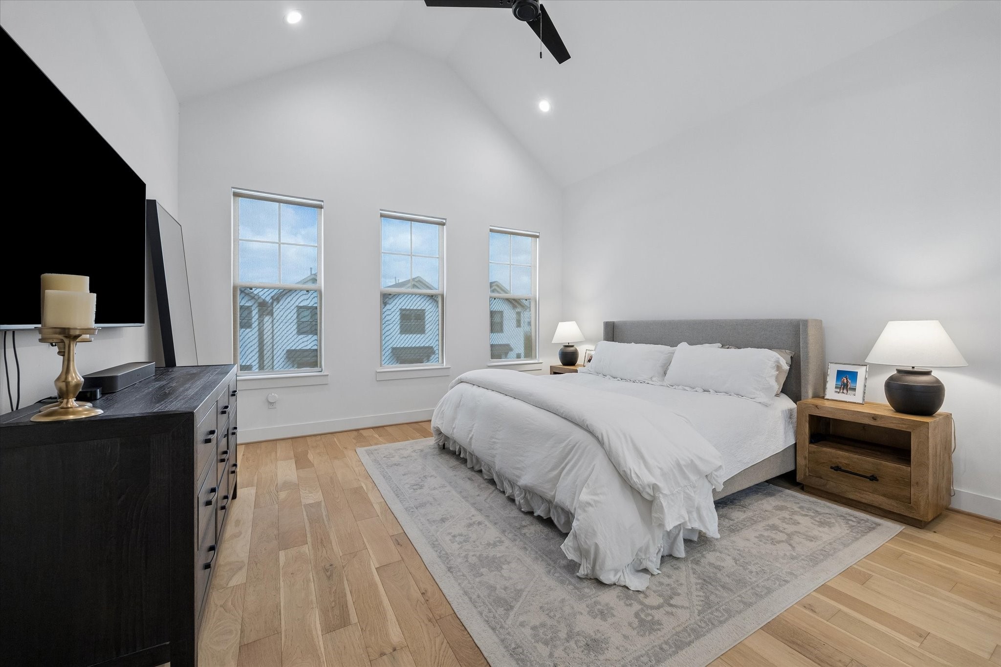 2407 Bevis Street Houston, TX 77008 - Photo 20 of 34 a spacious bedroom with a bed and a flat screen tv