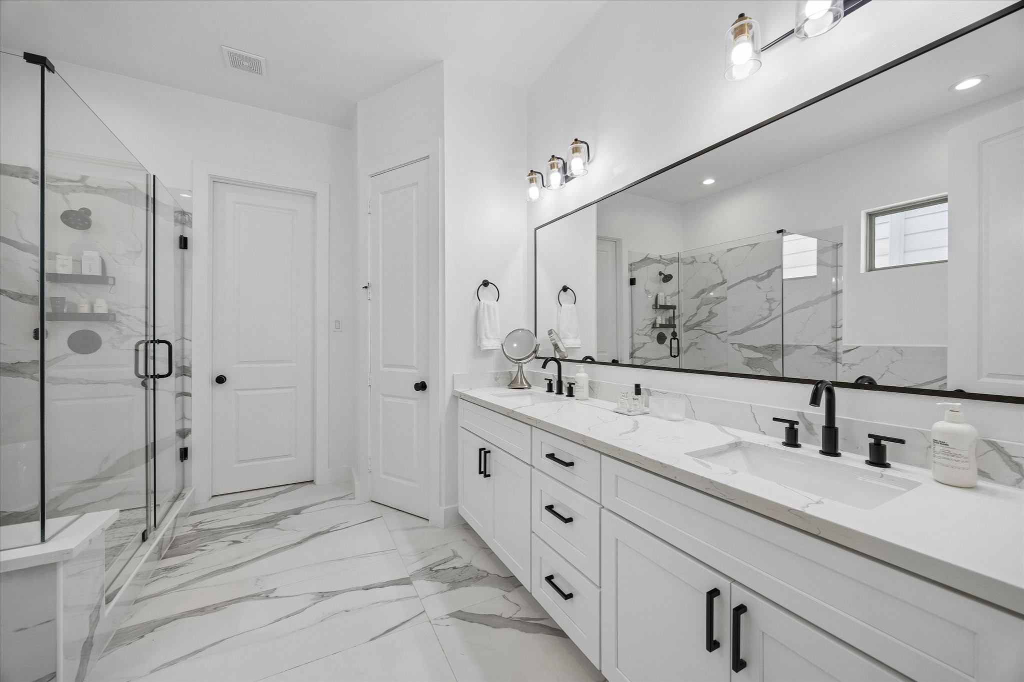2407 Bevis Street Houston, TX 77008 - Photo 22 of 34 a bathroom with double sink and a mirror