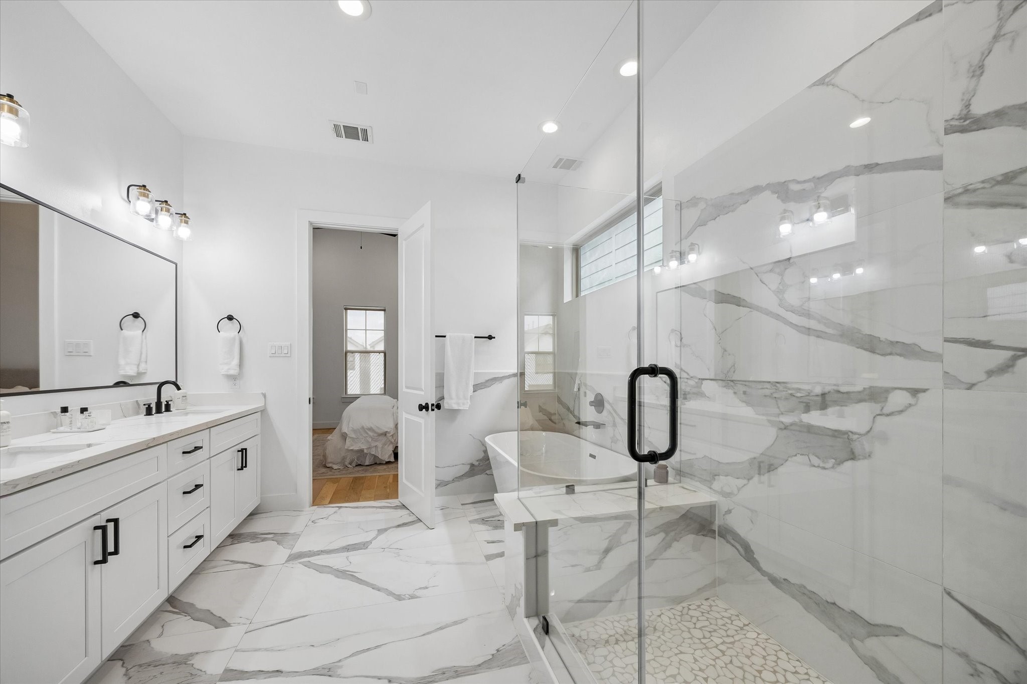 2407 Bevis Street Houston, TX 77008 - Photo 24 of 34 a bathroom with a double vanity sink mirror double shower