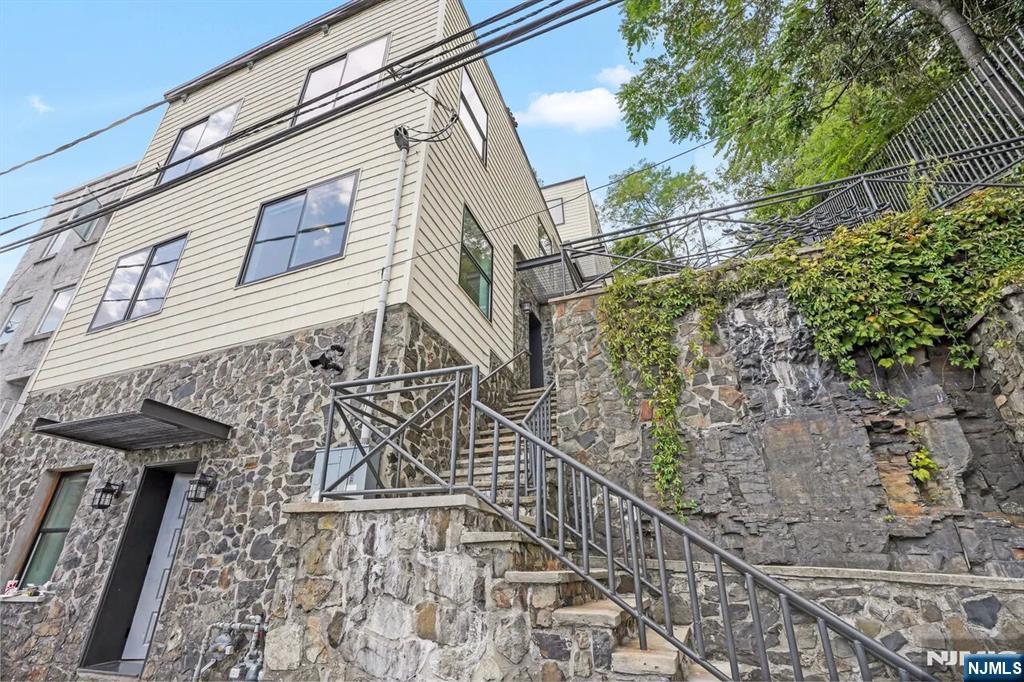 9009 Riverside Place, Unit 1 North Bergen, NJ 07047 - Photo 11 of 12 a view of a brick house with large windows