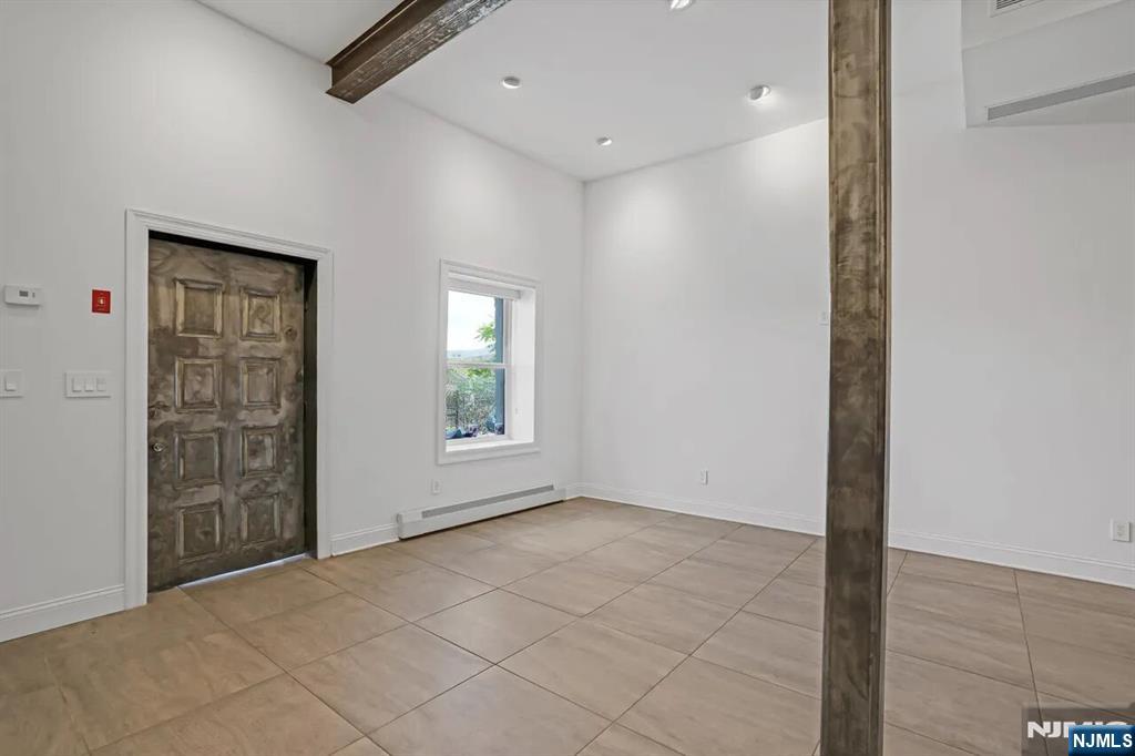 9009 Riverside Place, Unit 1 North Bergen, NJ 07047 - Photo 3 of 12 an empty room with windows