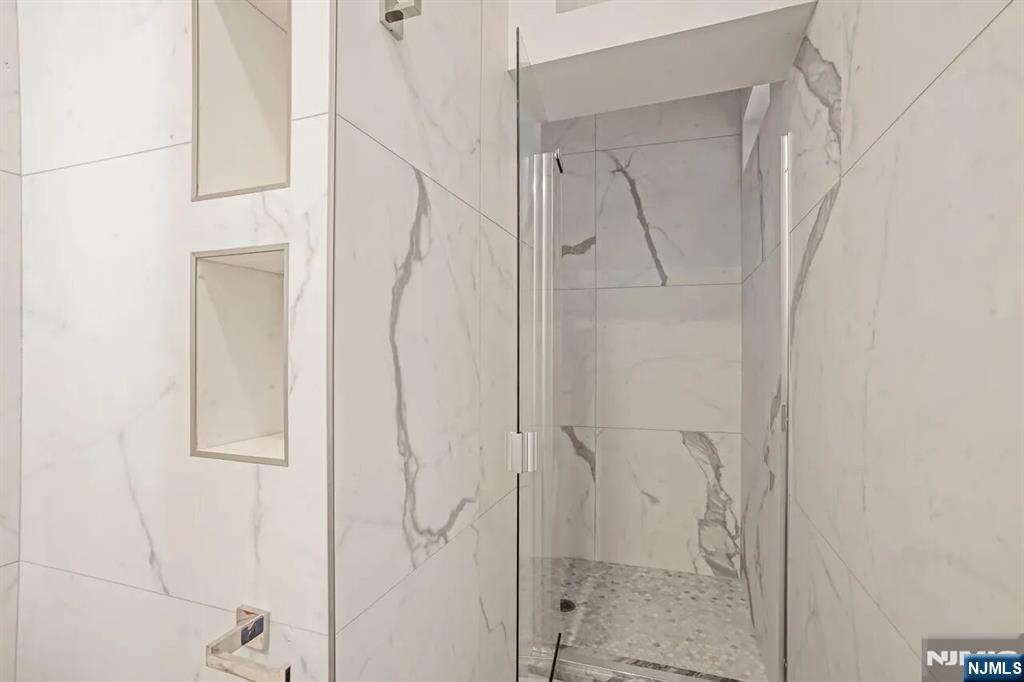 9009 Riverside Place, Unit 1 North Bergen, NJ 07047 - Photo 10 of 12 a bathroom with a glass shower door
