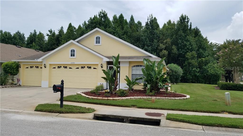20904 Ruby Red Way Land O Lakes, FL 34637 - Photo 1 of 1 a front view of a house with a yard and garage