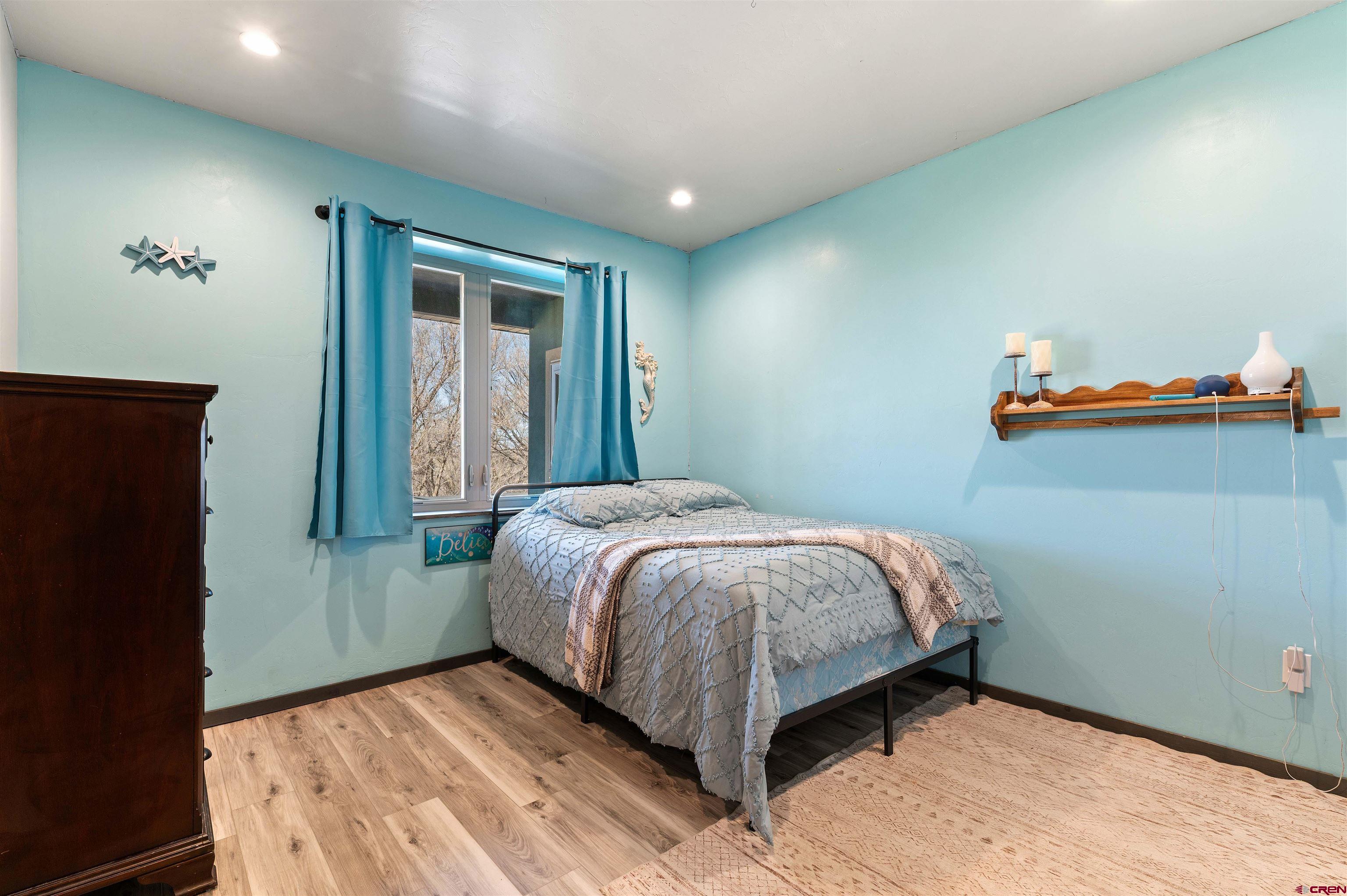 55347 Begonia Road Delta, CO 81416 - Photo 15 of 44 a bed sitting in a bedroom next to a window