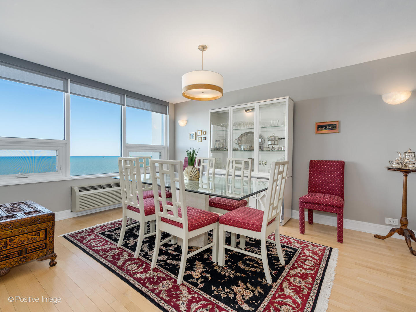 5733 North Sheridan Road, Unit 22C Chicago, IL 60660 - Photo 12 of 29 a dining room with furniture a rug and a chandelier