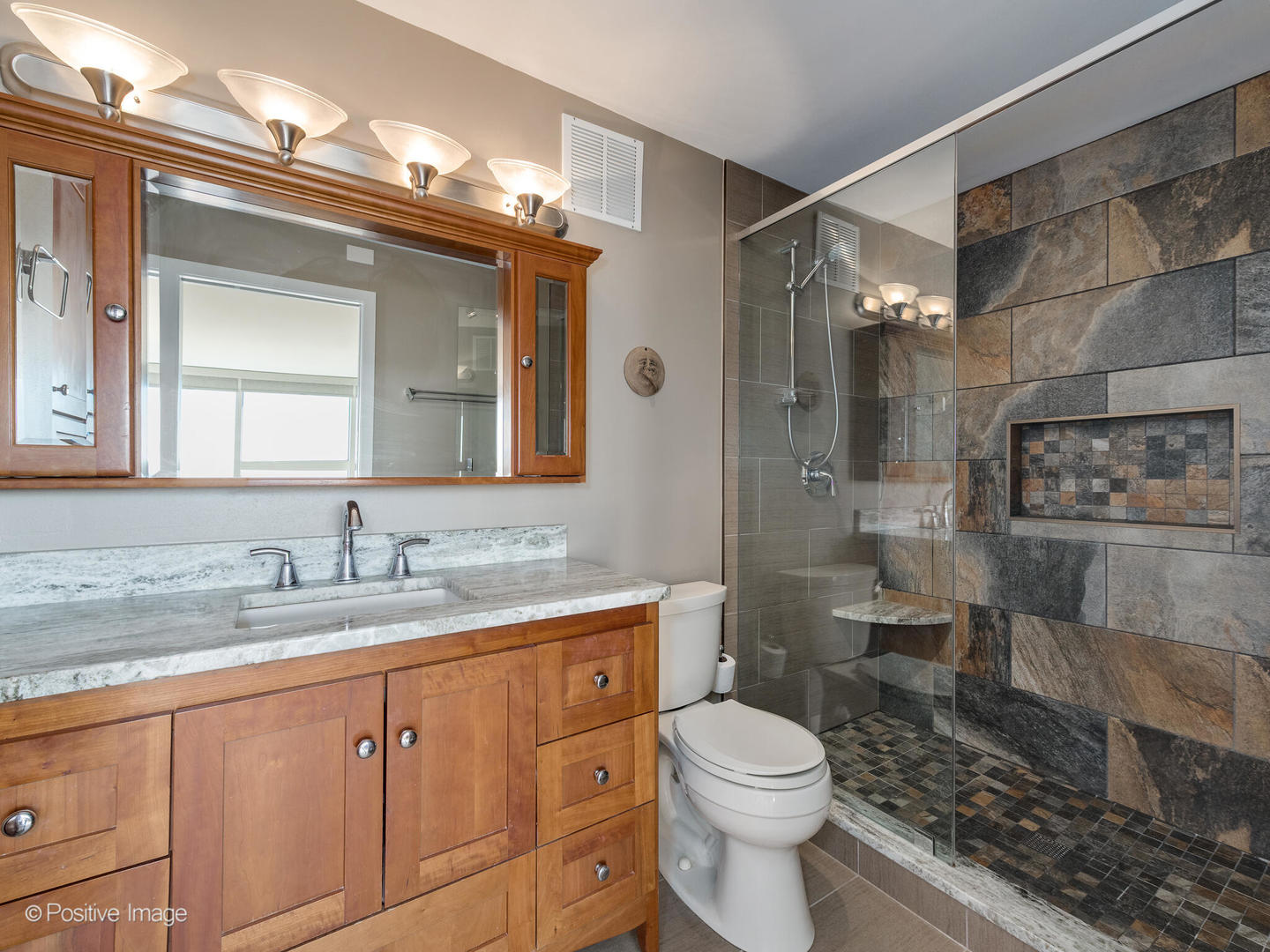 5733 North Sheridan Road, Unit 22C Chicago, IL 60660 - Photo 15 of 29 a bathroom with a granite countertop sink a toilet and a mirror